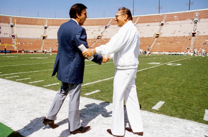 Tom Flores, then with the Seattle Seahawks, greets Raiders owner Al Davis before a game